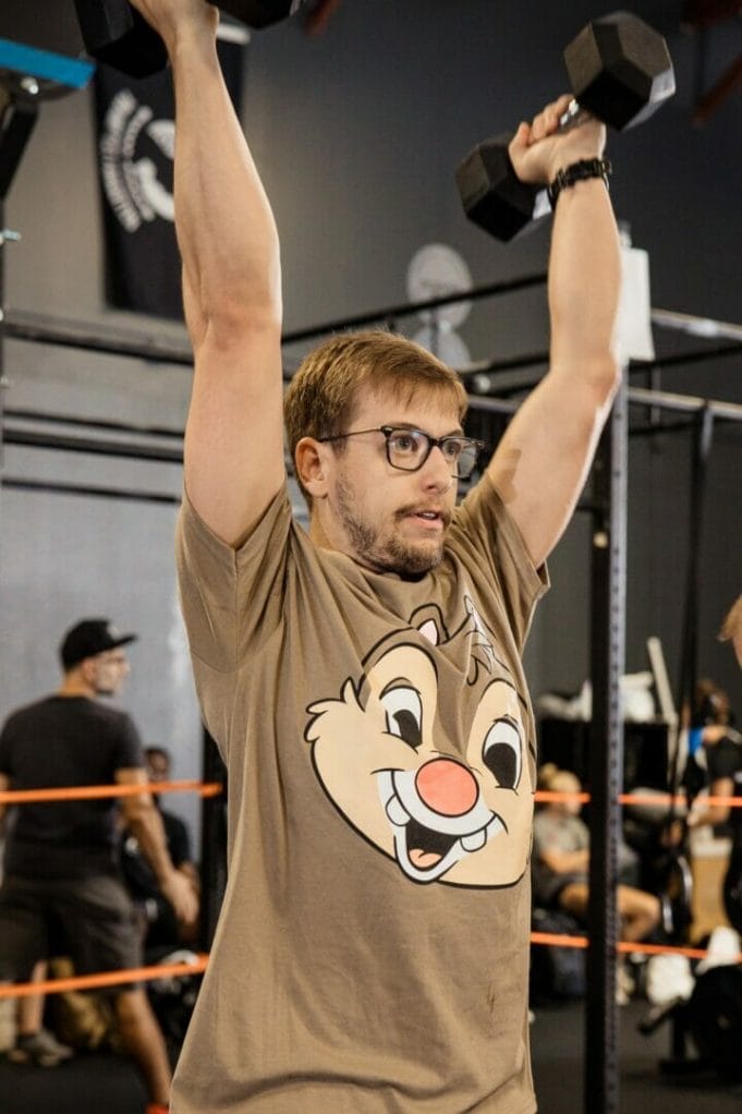 Calvin Thain lifting two bumbles in a CrossFit competition  